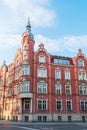 The building of the town hall from 1904. Red brick facade. Beautiful blue sky. The richly decorated facade of the tenement house. Royalty Free Stock Photo