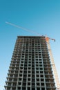 A multi-storey building under construction with a tower crane. Royalty Free Stock Photo