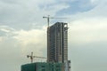 Building under construction, Condo construction, Building site with yellow cranes, and blue sky background Royalty Free Stock Photo