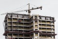 Building under construction with a crane on top. Royalty Free Stock Photo