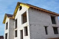 Building under construction new house from aerated concrete blocks with metal roof and unfinished soffits. Economic growth concept Royalty Free Stock Photo