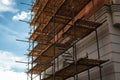 Building under construction with scaffolds, house renovation. Scaffolding on the construction site