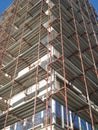 Building under rehabilitation with walls covered by metal scaffolds
