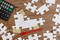 Close-Up White Jigsaw Pattern Puzzle Pieces To Be Connected With Missing Last Piece Positioned On A Flat Lay Background With Royalty Free Stock Photo