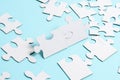 Close-Up White Jigsaw Pattern Puzzle Pieces To Be Connected With Missing Last Piece Positioned On A Flat Lay Background With Royalty Free Stock Photo