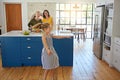 Building up an appetite. a little girl dancing while her mother and grandmother cooks in the background.