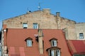 Building wall in bad condition above red metal roof in old town of Riga Royalty Free Stock Photo