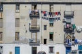 Building wall with balconies and clothes drying between neighbors