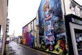 Building wall decorated in coloured graffiti