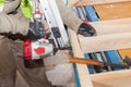 Building a wall for frame house.Worker use Framing Nailer to attach wooden beams. Royalty Free Stock Photo