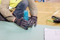 Building a wall for frame house. Worker use Laminate Trimmer for cutting drywall. Royalty Free Stock Photo