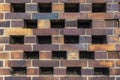 Building wall made of dark, yellow to brownish clinker bricks with various alternating patterns. The stones are offset in rows,