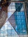 A building in Warsaw, Poland, with mirrored glass windows, supported by steel and iron frames, checkered, reflecting the blue sky Royalty Free Stock Photo