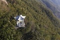 Building of white stone pavilion halfway up the mountain