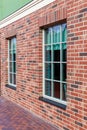 Building with windows to the street. fragment of a brick facade. Large white windows Royalty Free Stock Photo