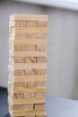 Building from wooden blocks. Game for family of wooden bars. Wood blocks stack game with Hand on background. Block tower with Royalty Free Stock Photo