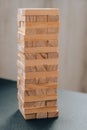 Building from wooden blocks. Game for family of wooden bars. Wood blocks stack game with Hand on background. Block tower with Royalty Free Stock Photo