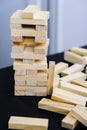 Building from wooden blocks. Game for family of wooden bars. Wood blocks stack game with Hand on background. Block tower with Royalty Free Stock Photo