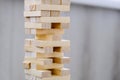 Building from wooden blocks. Game for family of wooden bars. Wood blocks stack game with Hand on background. Block tower Royalty Free Stock Photo