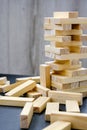Building from wooden blocks. Game for family of wooden bars. Wood blocks stack game with Hand on background. Block tower Royalty Free Stock Photo