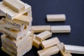 Building from wooden blocks. Game for family of wooden bars. Wood blocks stack game with Hand on background. Block tower Royalty Free Stock Photo