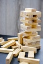 Building from wooden blocks. Game for family of wooden bars. Wood blocks stack game with Hand on background. Block tower Royalty Free Stock Photo