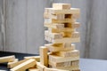 Building from wooden blocks - jenga. Game for family of wooden bars. Wood blocks stack game with Hand on background. Block tower Royalty Free Stock Photo