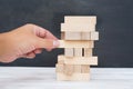 Building from wooden blocks. Wood blocks stack game with Hand on background. Conceptual of Teamwork. Block tower with architecture Royalty Free Stock Photo
