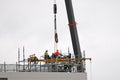 Building series. Workers removing the Construction Crane on the new Multistory Unit building under construction at 277 Mann St. Royalty Free Stock Photo