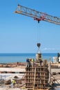 Building worker pouring concrete on the top of the construction site