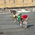 Building workers lay reinforcement