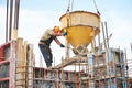 Building workers pouring concrete with barrel