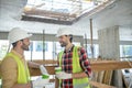 Building workers in yellow vests and gloves having coffee break Royalty Free Stock Photo