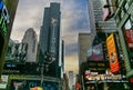 Buildings and advertisements on 44th Street in Times Square on an overcast sky in New York, USA