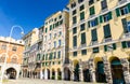 Buildings with arches, archways, portico and shutters on windows on Piazza Della Raibetta square in historical centre of old europ