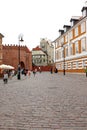 Road leading up to a gate in the old wall in Warsaw Old Town