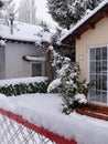 Buildings and backyards covered with snow in Villanua village in Aragon, Spain. Vertical photo