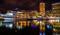 Buildings and boats reflecting in the Inner Harbor at night, Baltimore, Maryland. Royalty Free Stock Photo