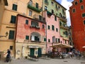 Pink weathered building facades and outdoor cafes in Camogli, Italy