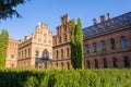 Buildings and campus with patterned ornamented roof by multicolored tiles in greenery side view. Architecture University of Cherni