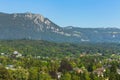 Buildings of the city of Solothurn among green trees, summits of the Alps in the background