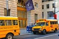 Buildings, classic architecture, yellow school bus with driver on the street in wall street in manhattan in new york Royalty Free Stock Photo