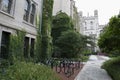 Buildings in English gothic style, garden trees and bicycles