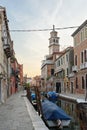 Buildings on the Rio de S. Barnaba waterway and the tower of the parish church of Our Lady of Mount Carmel. Venezia, Italy