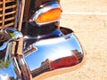 Buildings of historic downtown Sapulpa Oklahoma reflected in the chrome bumper of a restored automobile. Auto show on Route 66.