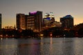 Buildings, Hotels and Church domes in front Lake Eola Park on beatiful sunset background.