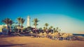 Buildings of the luxury hotel and palm alley on egyptian beach, lighthouse. Red Sea. Egypt.