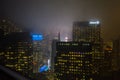 Buildings in Manhattan New York City Fading Away in the Fog at Winter During Night. Illuminated Billboards at Times Square Royalty Free Stock Photo