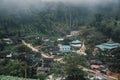 Buildings in mountain village. Foggy day, Top view village landscape Royalty Free Stock Photo