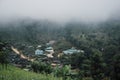 Buildings in mountain village. Foggy day, Top view village landscape Royalty Free Stock Photo